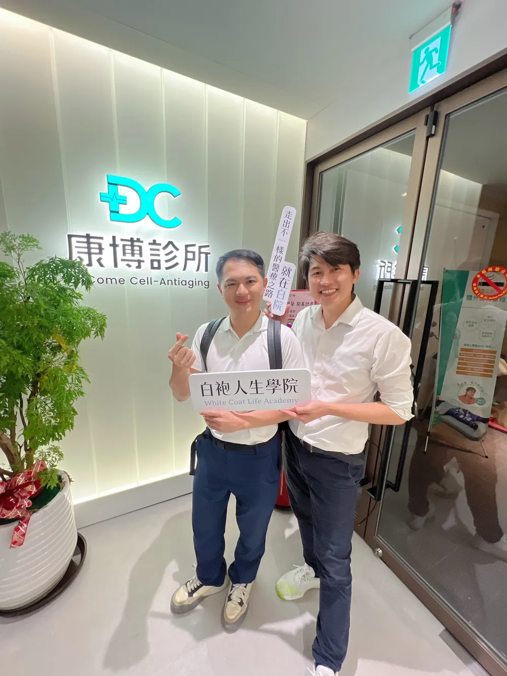 張益豪醫師與胡守丞醫師靠近鏡頭，再拍一張舉立牌的合照
